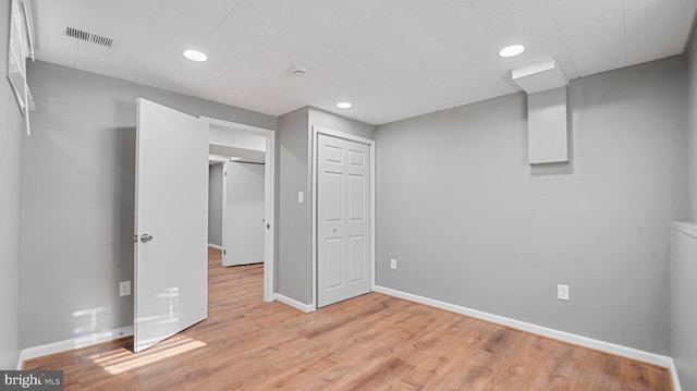 below grade area with recessed lighting, baseboards, visible vents, and light wood finished floors