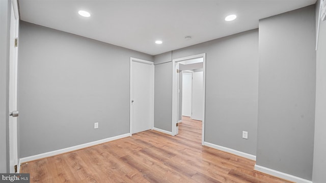 unfurnished bedroom featuring recessed lighting, baseboards, and wood finished floors