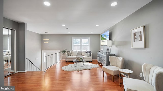 living room with recessed lighting, baseboards, and wood finished floors