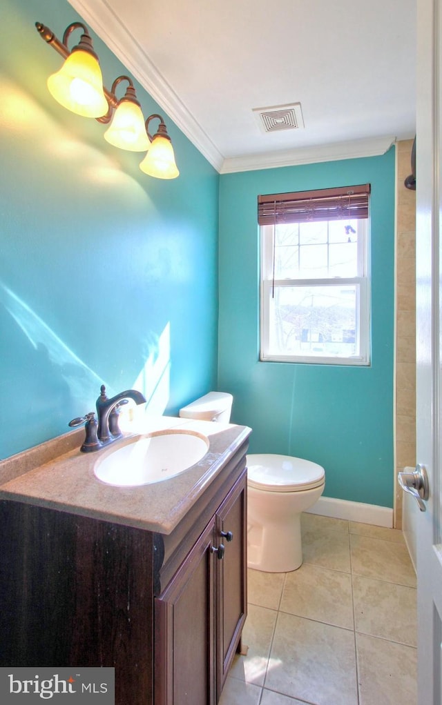 bathroom with tile patterned flooring, crown molding, vanity, and toilet
