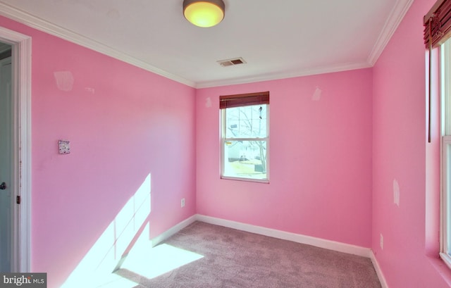 empty room with ornamental molding and light carpet