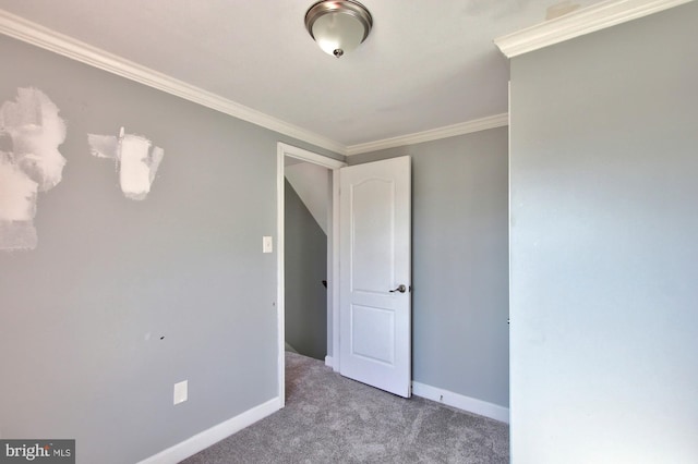 carpeted spare room featuring ornamental molding