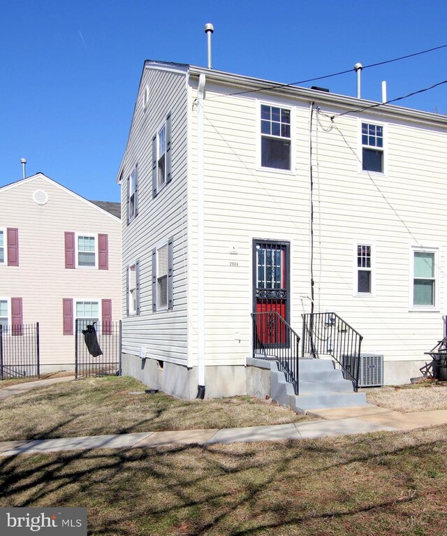 rear view of house with central AC unit