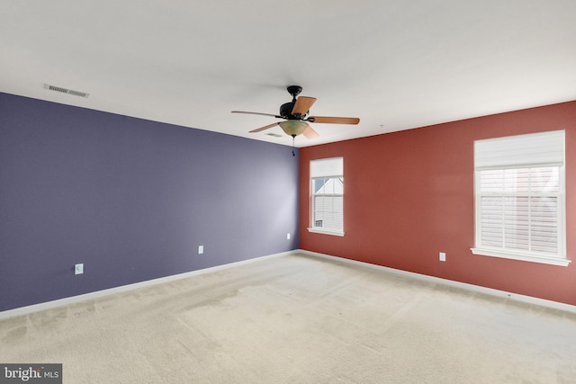 empty room featuring carpet floors and ceiling fan