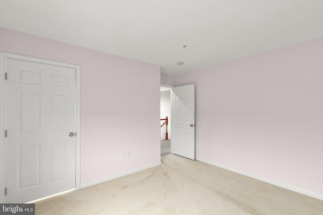 unfurnished bedroom featuring light colored carpet