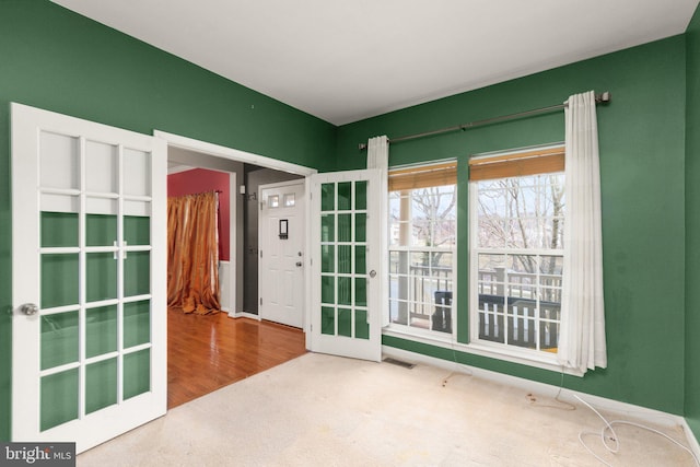 unfurnished room featuring french doors