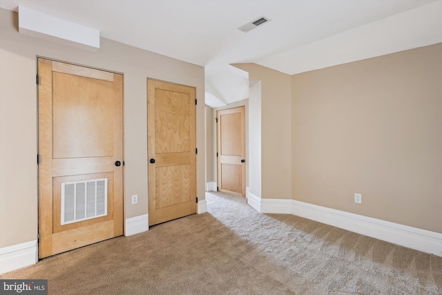 unfurnished bedroom with baseboards, visible vents, and carpet flooring