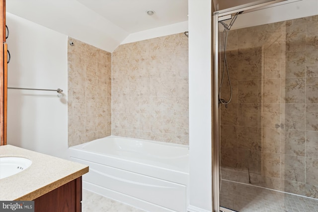 full bathroom featuring a shower stall, a bath, and vanity