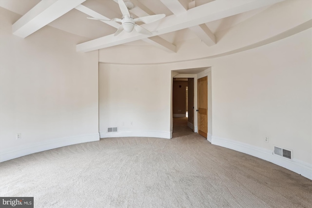 carpeted empty room with beamed ceiling, visible vents, and baseboards
