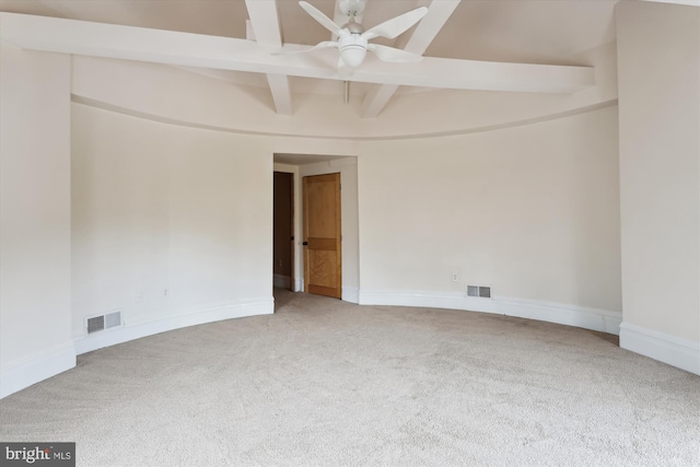 carpeted empty room with beamed ceiling, baseboards, visible vents, and ceiling fan