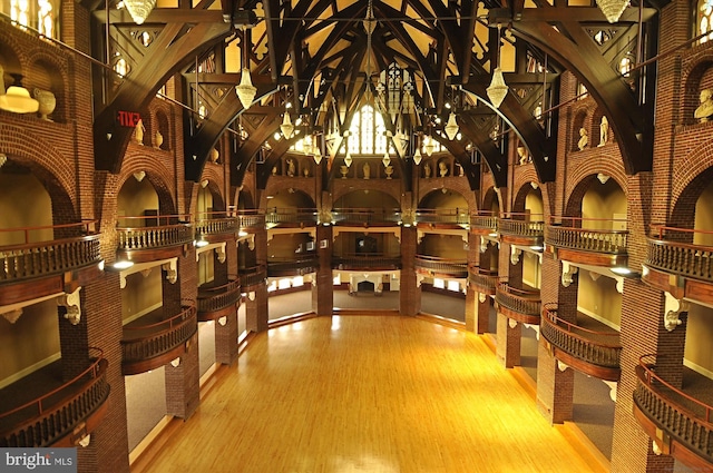 wine cellar featuring wood finished floors and a chandelier