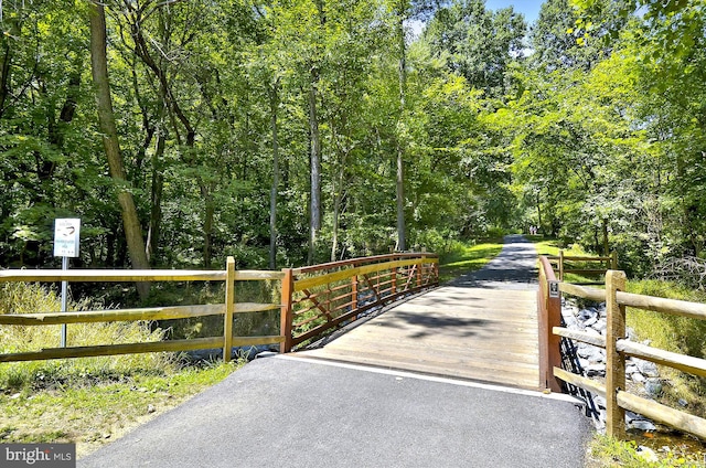 view of gate with a forest view