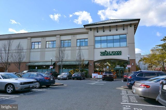 view of building exterior featuring uncovered parking