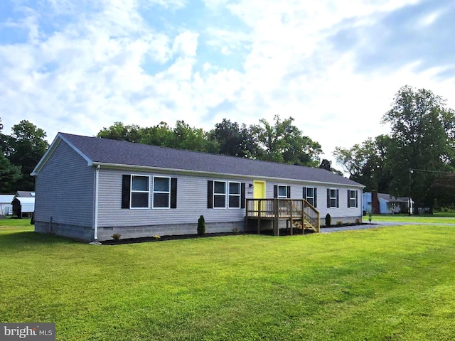 view of front of property with a front yard and a deck