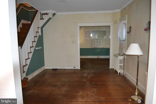 interior space featuring crown molding, radiator heating unit, and dark hardwood / wood-style floors