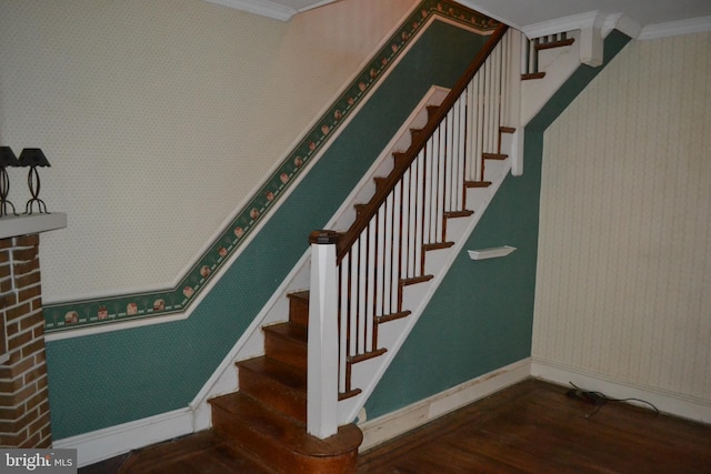 stairs featuring hardwood / wood-style flooring and crown molding