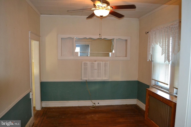 unfurnished room with crown molding, radiator, ceiling fan, and dark hardwood / wood-style flooring