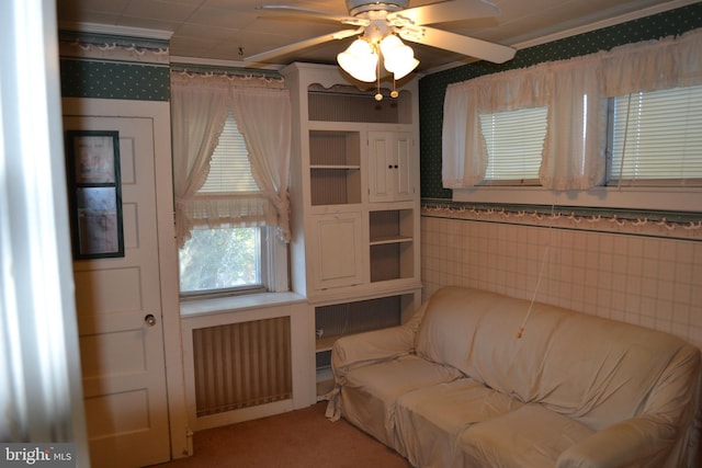 living area featuring radiator and ceiling fan