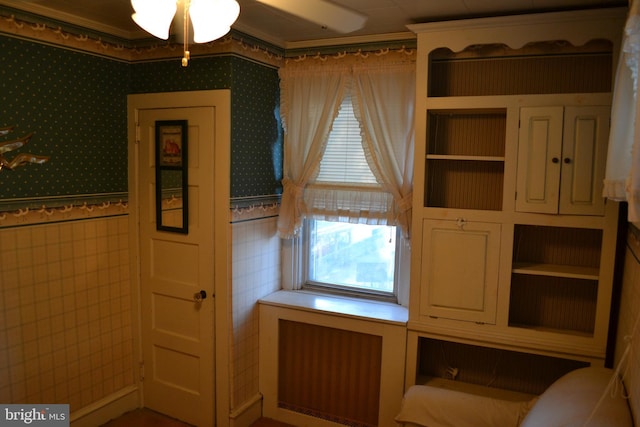 interior space with tile walls and radiator