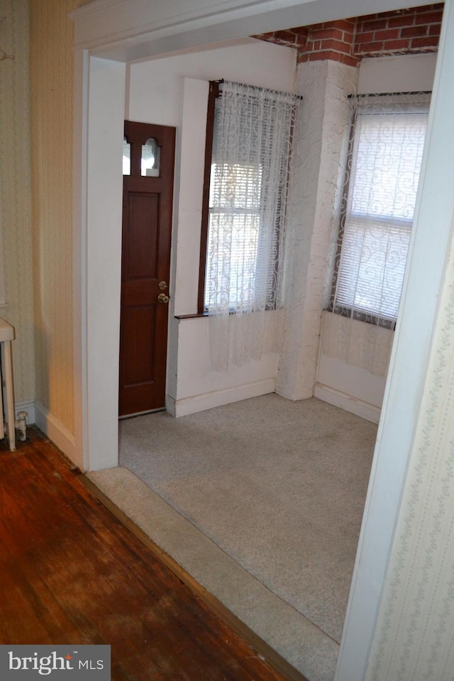 foyer entrance featuring hardwood / wood-style flooring and radiator heating unit