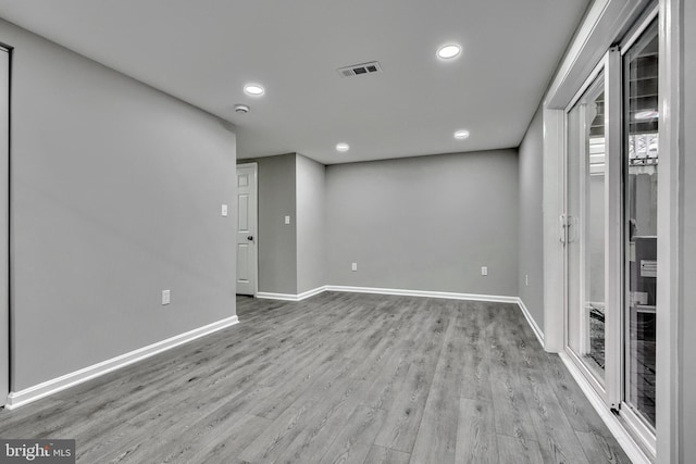 basement with light hardwood / wood-style floors