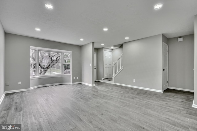 interior space featuring a textured ceiling and light hardwood / wood-style floors