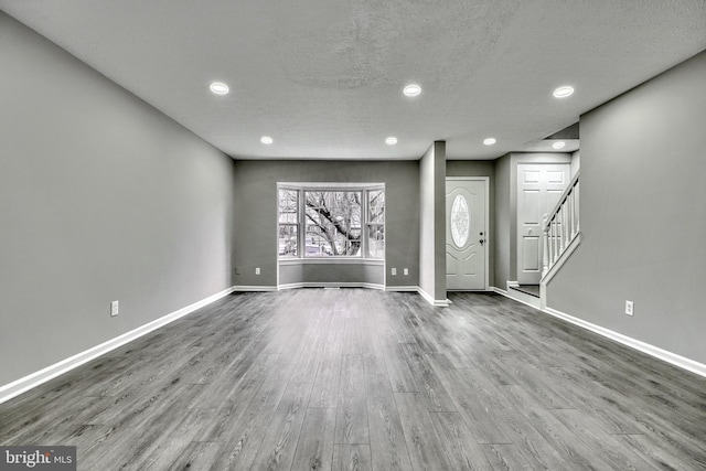 interior space with light hardwood / wood-style flooring and a textured ceiling