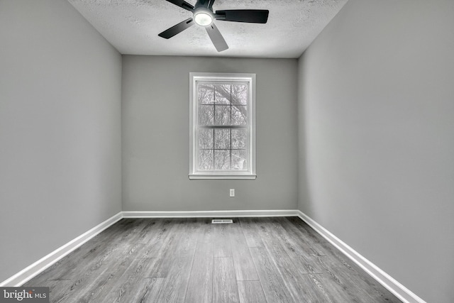 unfurnished room featuring ceiling fan, a textured ceiling, and light wood-type flooring