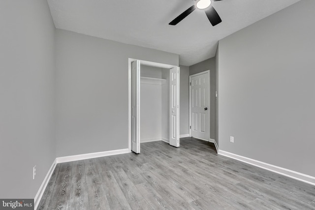 unfurnished bedroom featuring light hardwood / wood-style flooring, a closet, and ceiling fan