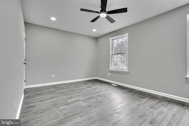 unfurnished room featuring ceiling fan and hardwood / wood-style floors