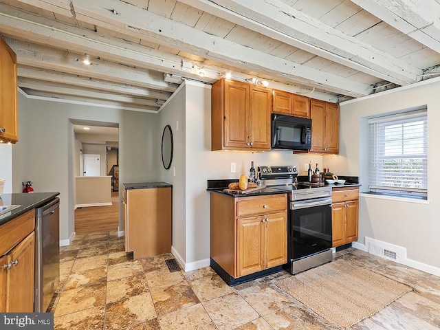 kitchen with stainless steel appliances, beam ceiling, dark countertops, and visible vents