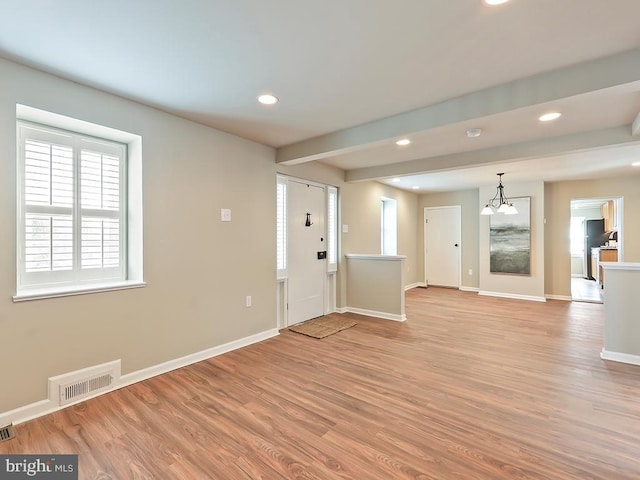 foyer entrance featuring baseboards, light wood-style floors, visible vents, and recessed lighting