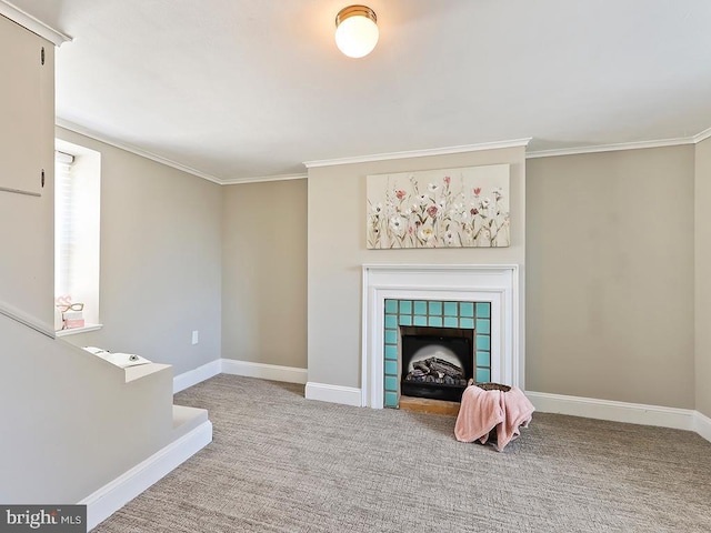 carpeted living room featuring ornamental molding, a tile fireplace, and baseboards