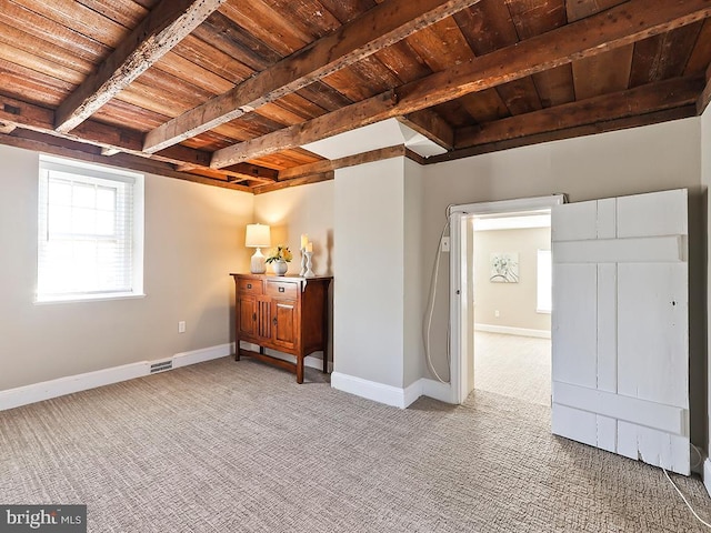 interior space with carpet, beam ceiling, visible vents, wood ceiling, and baseboards