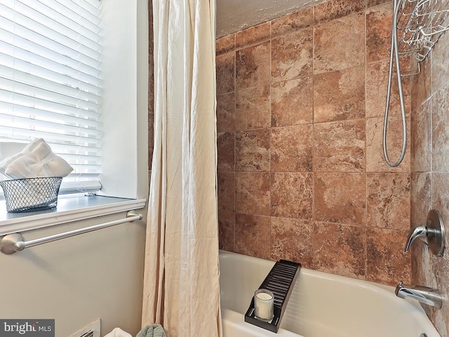 bathroom featuring shower / tub combo with curtain