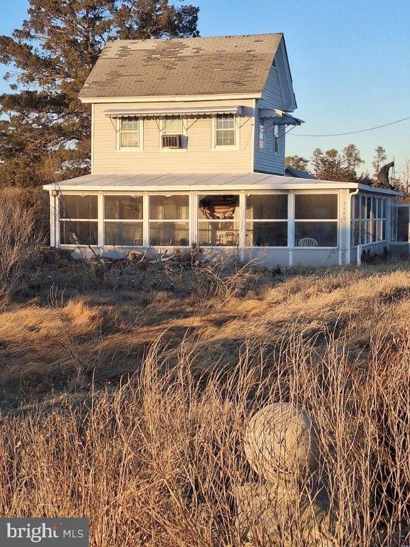 rear view of property with a sunroom