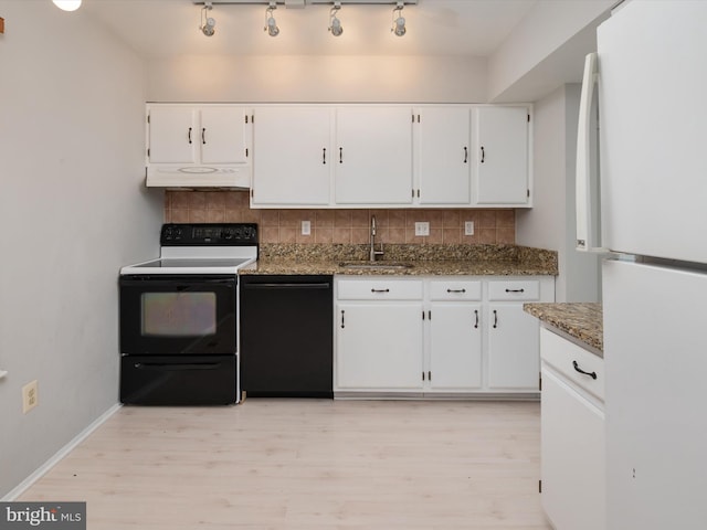 kitchen featuring dishwasher, electric stove, freestanding refrigerator, under cabinet range hood, and a sink