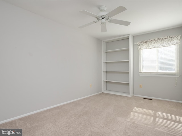 unfurnished bedroom with light carpet, visible vents, baseboards, and ceiling fan