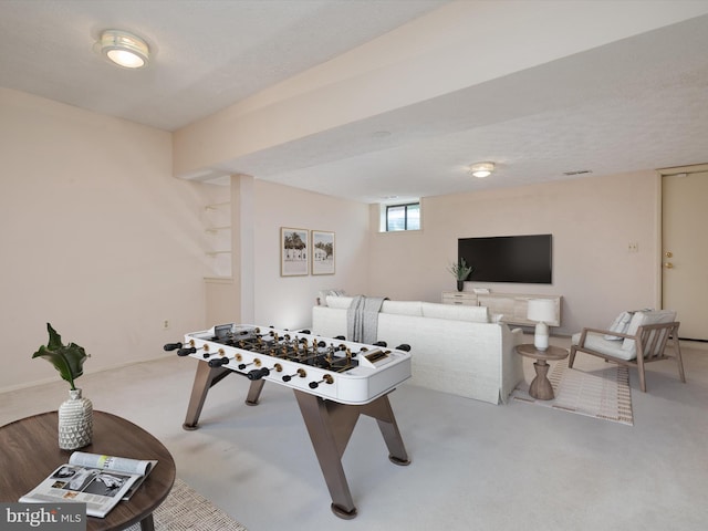 game room with light carpet and a textured ceiling