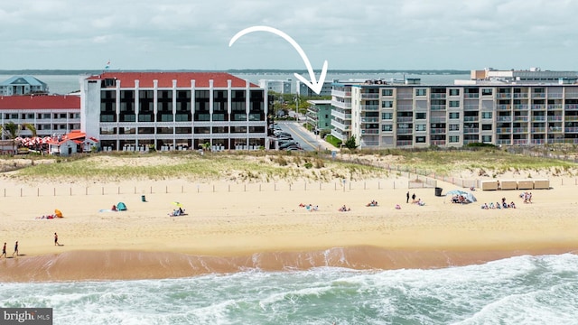 exterior space featuring a water view and a view of the beach