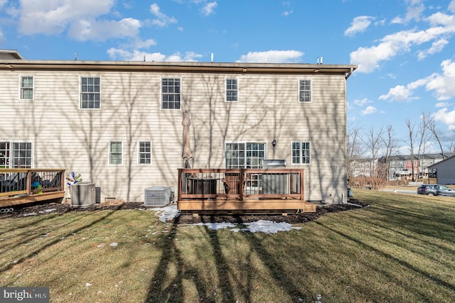 back of property featuring central AC, a lawn, and a deck