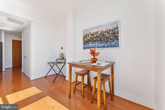 dining area with hardwood / wood-style flooring