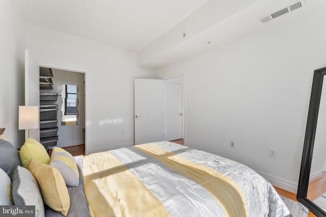 bedroom with hardwood / wood-style flooring