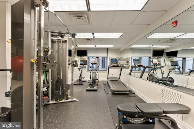 gym with a paneled ceiling