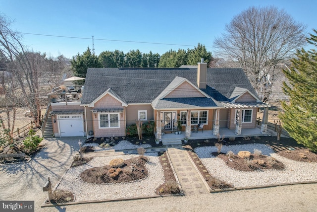 view of front of property featuring a garage and covered porch