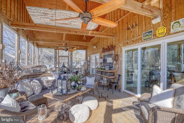 sunroom / solarium featuring vaulted ceiling with beams and ceiling fan