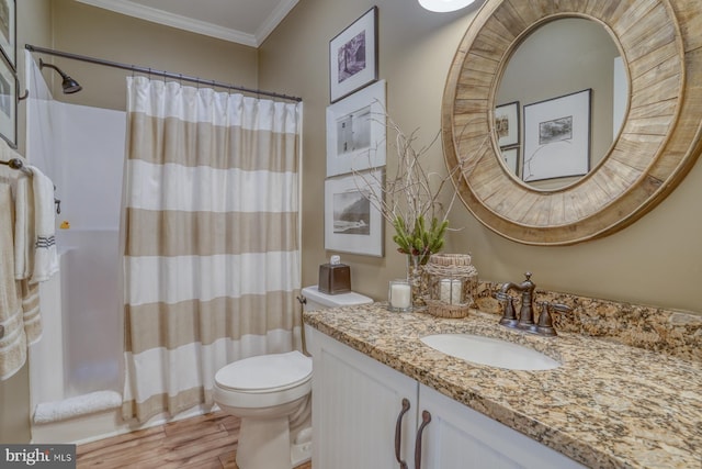 bathroom featuring hardwood / wood-style floors, ornamental molding, vanity, toilet, and a shower with curtain