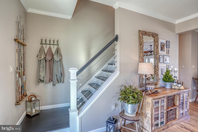 staircase with crown molding and hardwood / wood-style floors