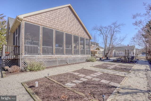 view of home's exterior with a sunroom