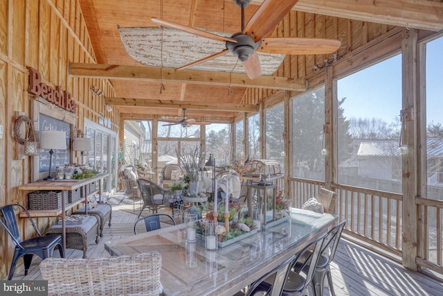 unfurnished sunroom with vaulted ceiling with beams and ceiling fan